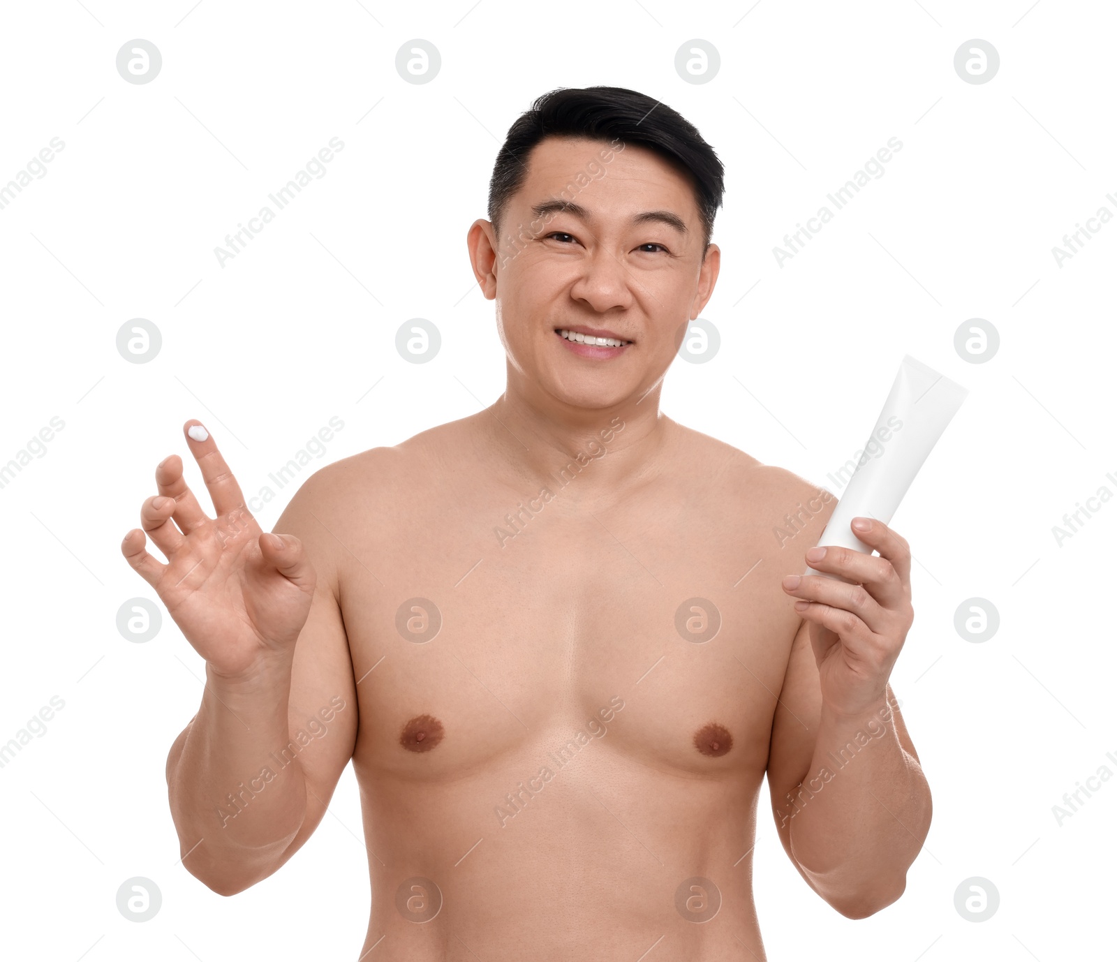 Photo of Handsome man with tube of body cream on white background