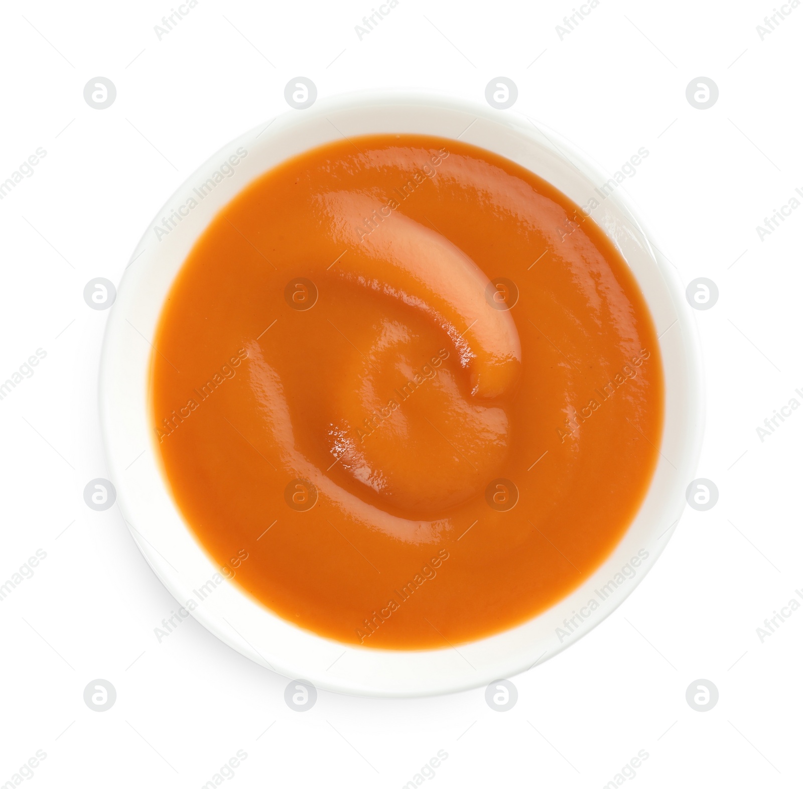 Photo of Delicious persimmon jam in bowl isolated on white, top view