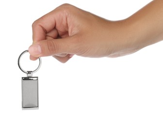 Photo of Woman holding metallic keychain on white background, closeup