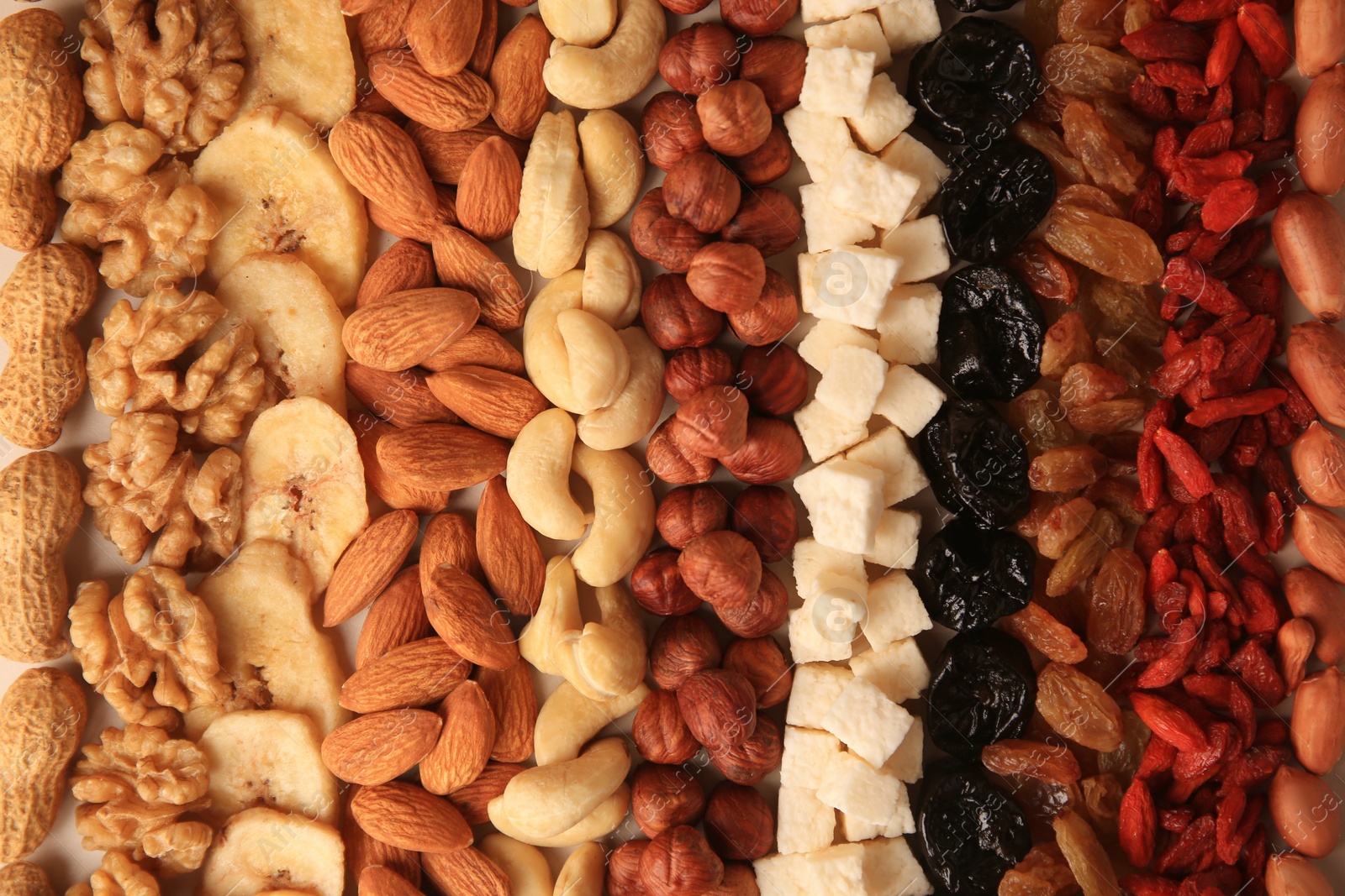 Photo of Different tasty nuts and dried fruits as background, top view