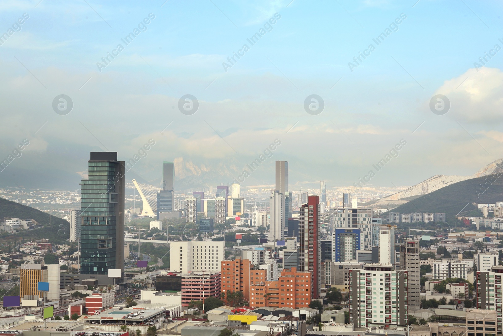 Photo of Picturesque view of cityscape with many buildings near mountain