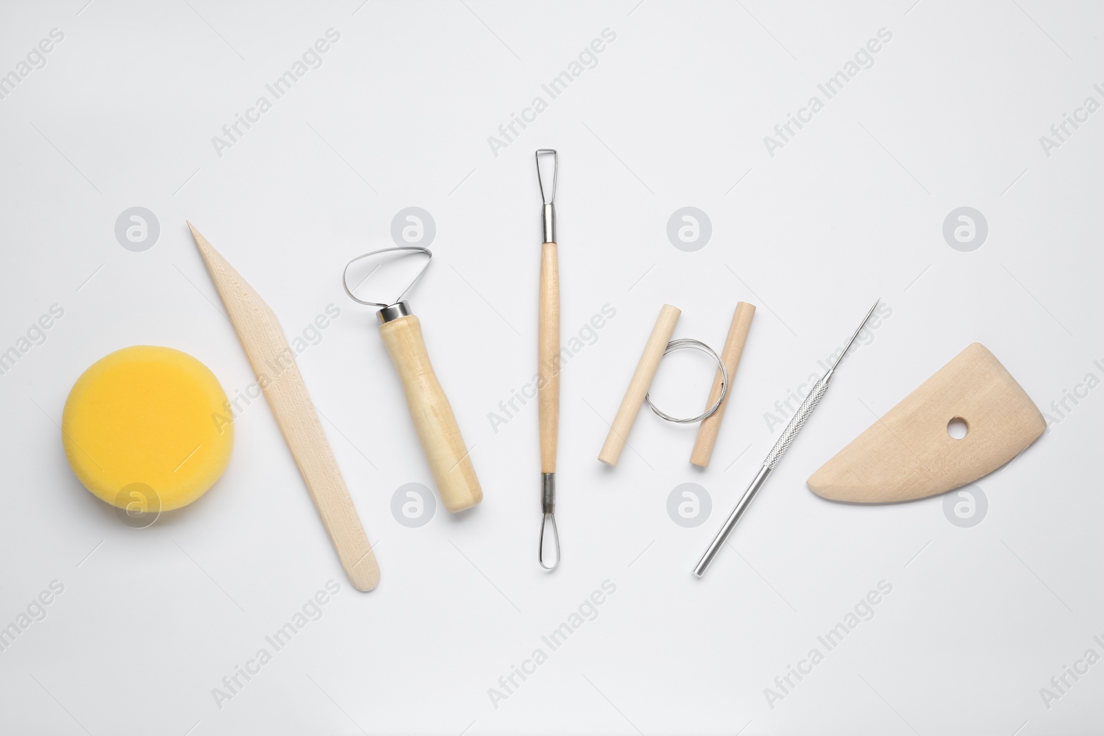 Photo of Set of clay modeling tools on white background, flat lay