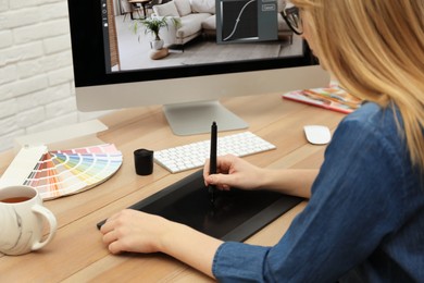 Photo of Professional retoucher working on graphic tablet at desk, closeup