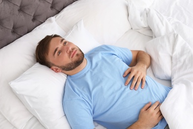 Young man lying in bed at home. Sleep disorder
