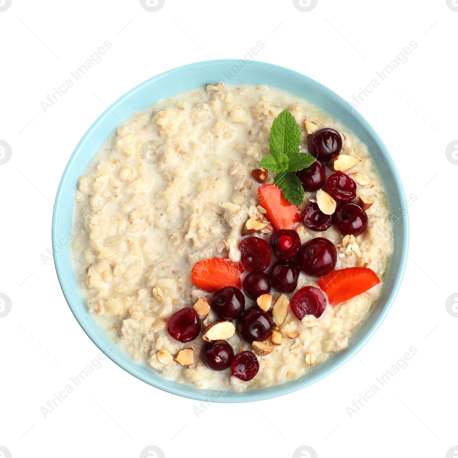 Photo of Bowl of oatmeal porridge with berries isolated on white, top view