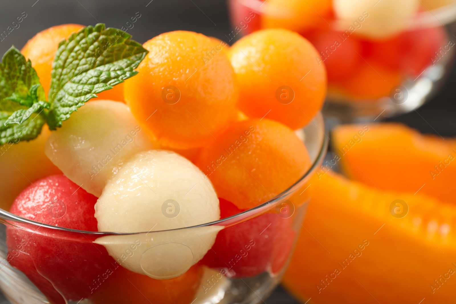 Photo of Melon and watermelon balls with mint in dessert bowl on table, closeup