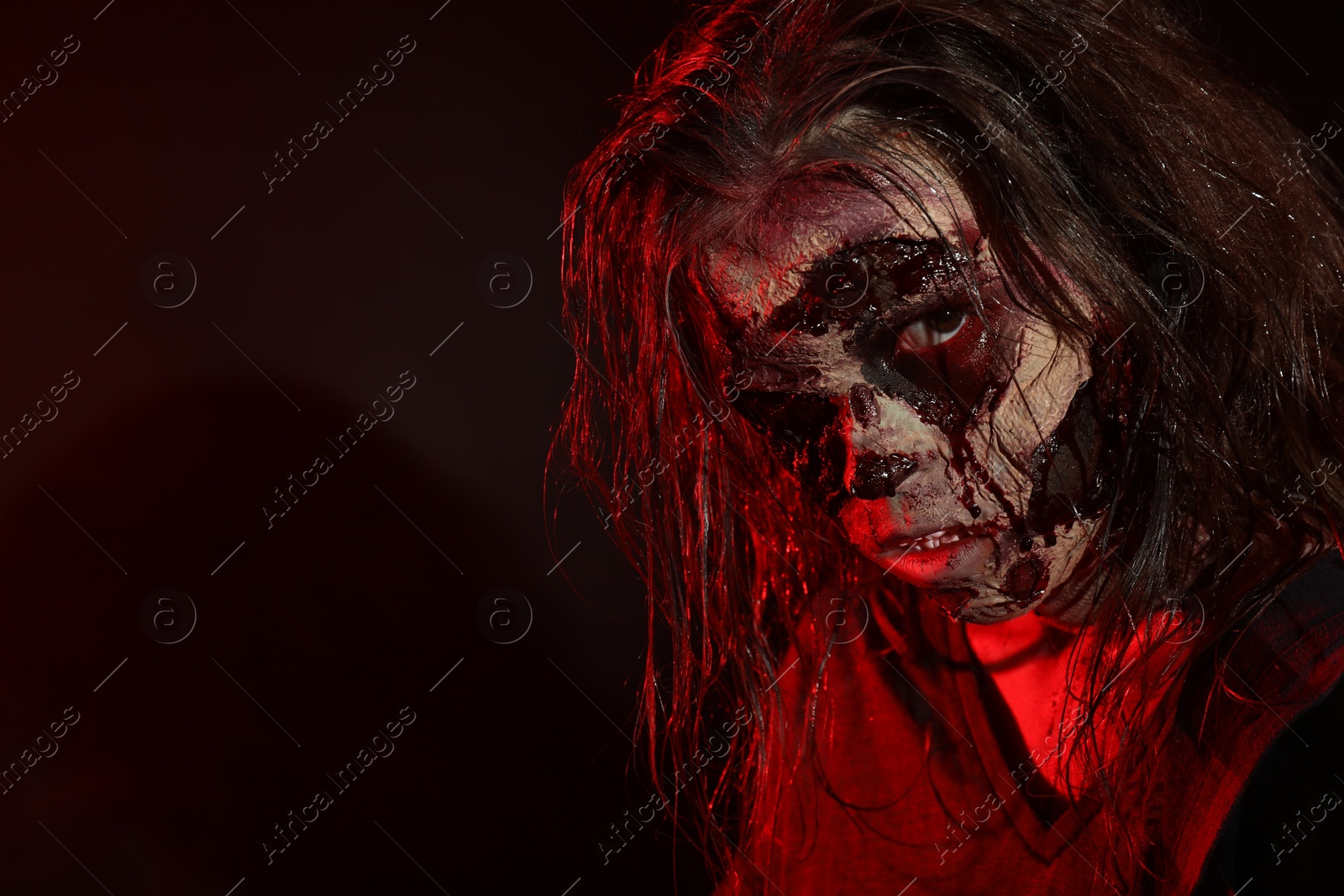 Photo of Scary zombie on dark background, space for text. Halloween monster