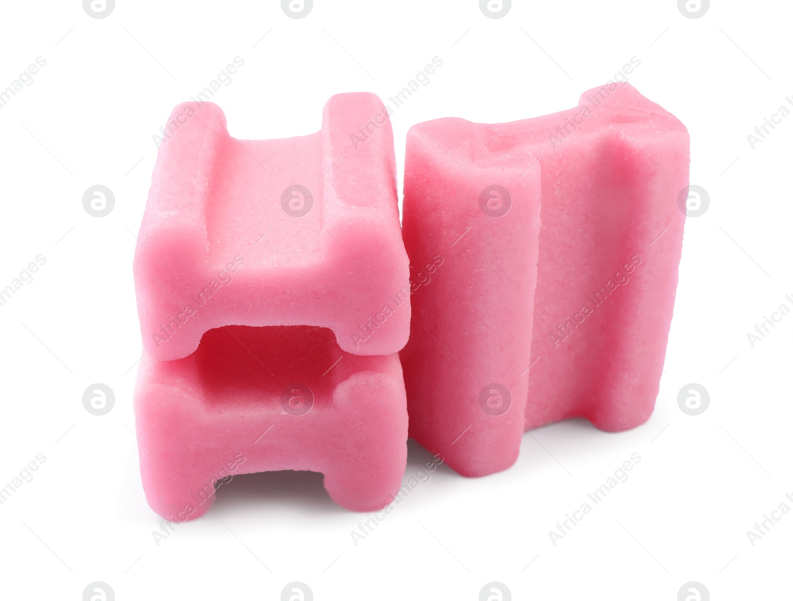 Photo of Tasty pink chewing gums on white background