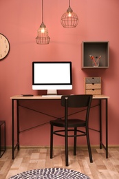 Photo of Comfortable workplace with computer on desk in home office