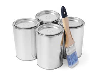 Cans of paints and brush on white background