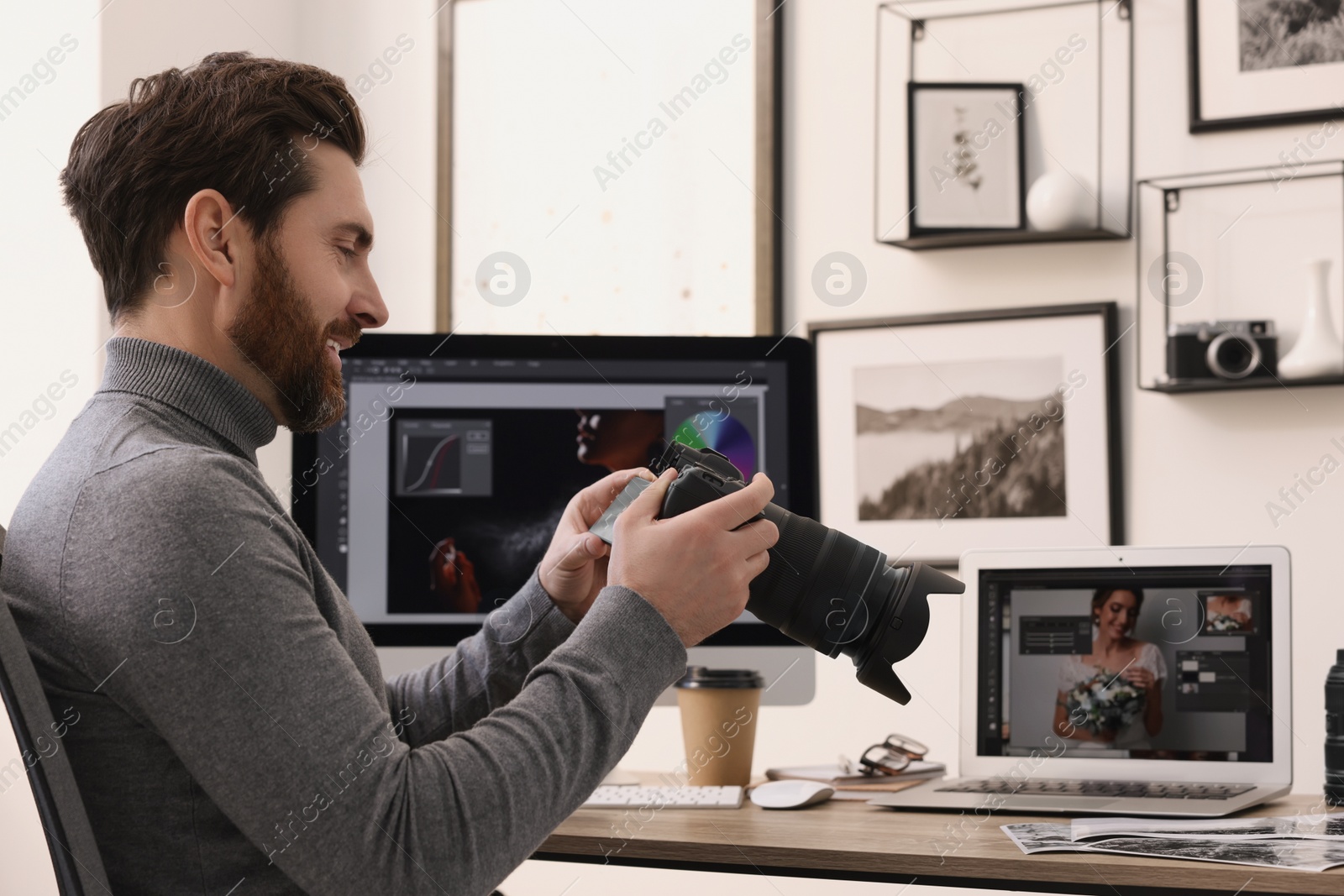 Photo of Professional photographer with digital camera at table in office