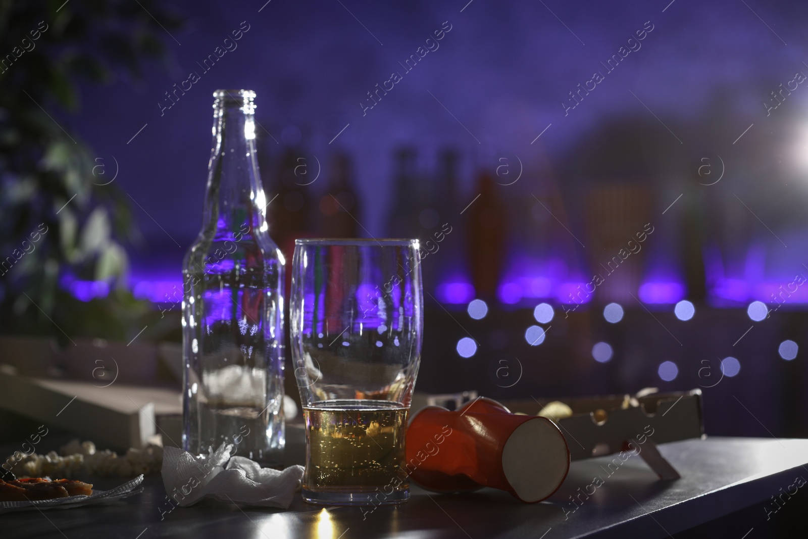 Photo of Messy table with beer and food leftovers indoors, space for text. After party chaos