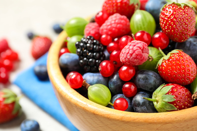 Photo of Mix of ripe berries in bowl, closeup