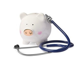 Photo of Piggy bank with stethoscope on white background. Medical insurance