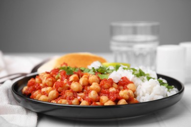 Photo of Delicious chickpea curry with rice on table, closeup