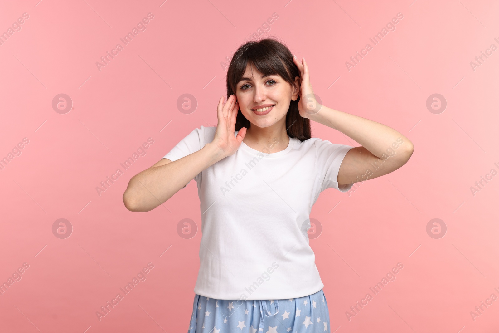 Photo of Happy woman in pyjama on pink background