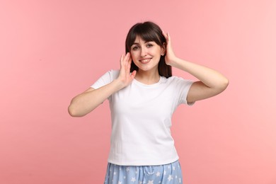 Photo of Happy woman in pyjama on pink background