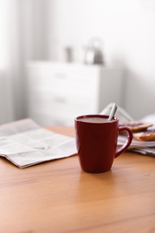 Photo of Morning coffee on wooden table indoors. Space for text
