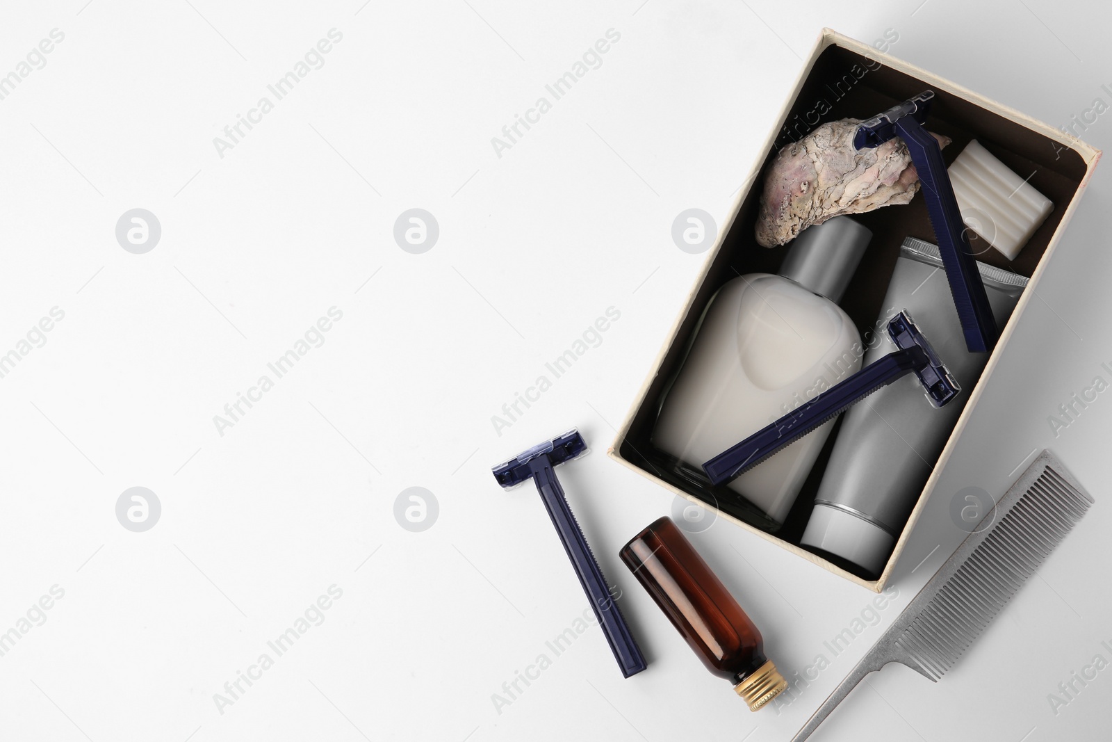 Photo of Different men's shaving accessories and box on white background, flat lay. Space for text