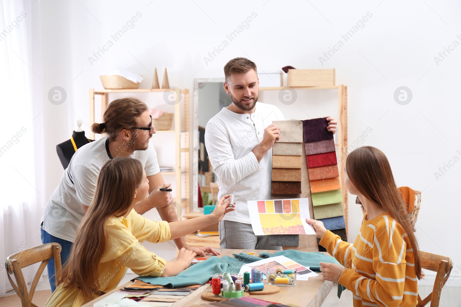 Photo of Fashion designers creating new clothes in studio