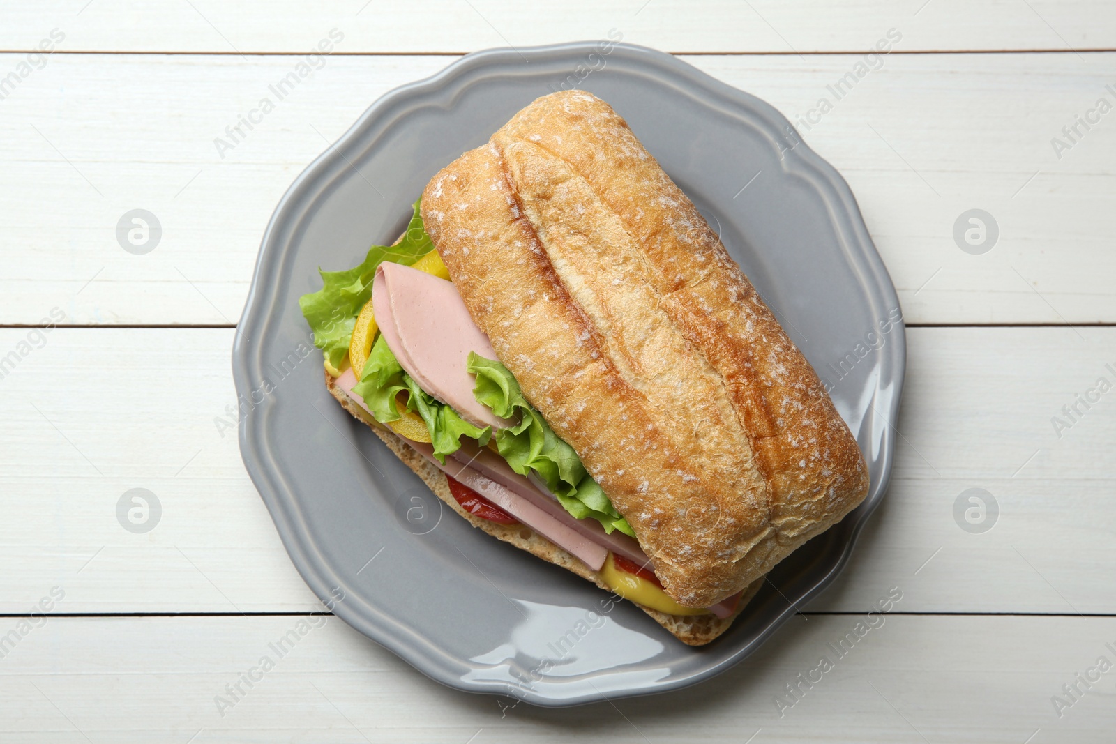 Photo of Tasty sandwich with boiled sausage, cheese and vegetables on white wooden table, top view