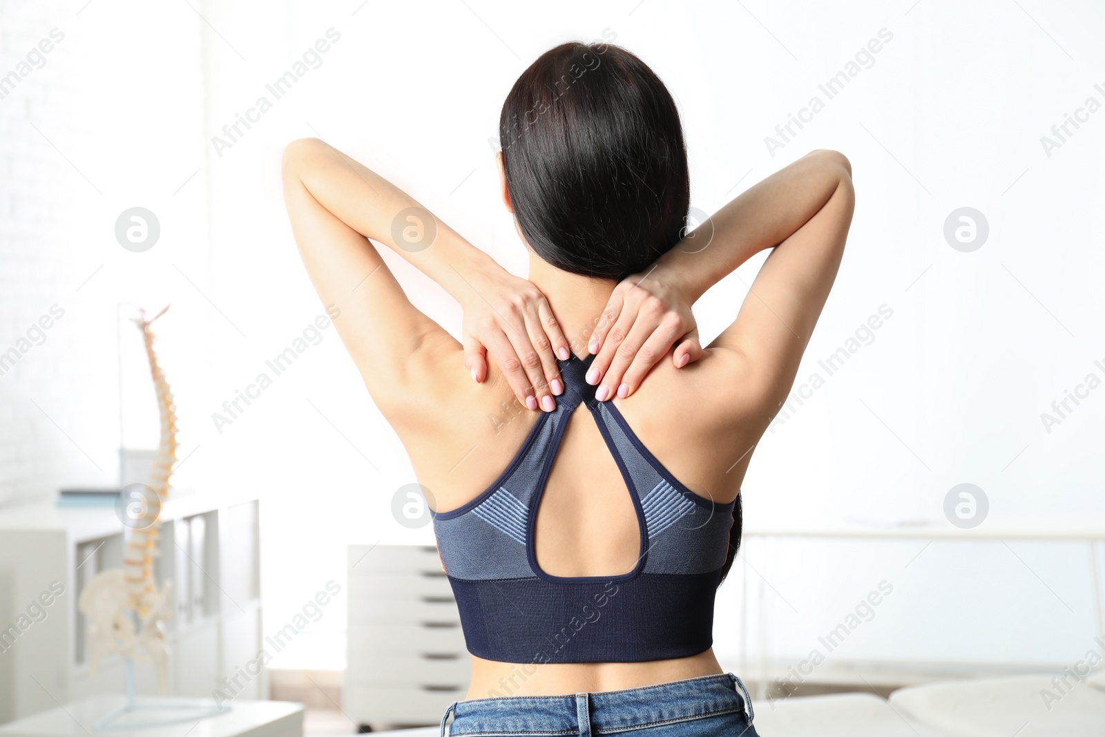 Photo of Woman suffering from pain in neck at clinic. Visiting orthopedist