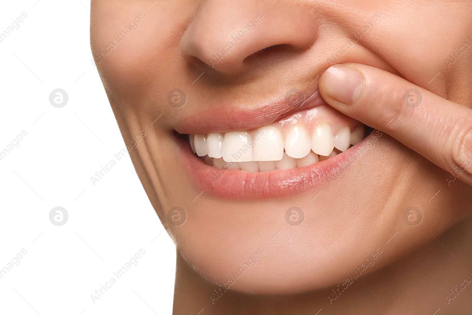 Photo of Woman showing healthy gums on white background, closeup