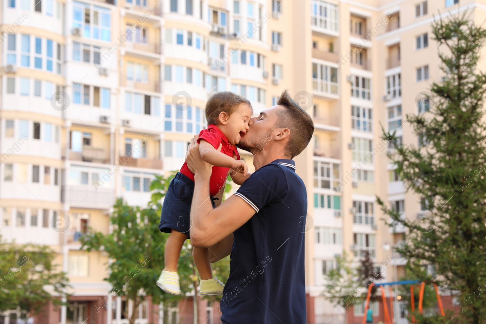 Photo of Father with adorable little baby outdoors. Happy family