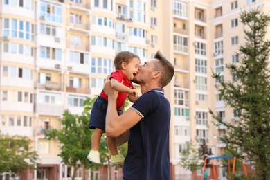 Father with adorable little baby outdoors. Happy family