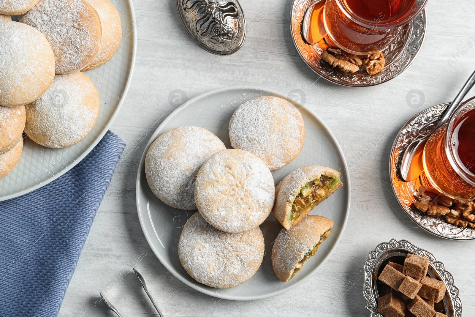 Photo of Flat lay composition with traditional cookies for Islamic holidays on table. Eid Mubarak