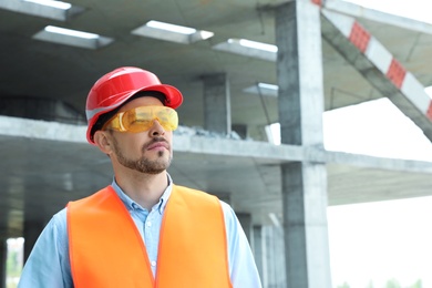 Professional engineer in safety equipment at construction site