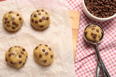 Photo of Uncooked chocolate chip cookies on cloth, flat lay