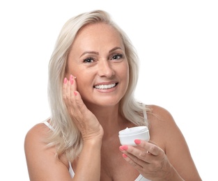 Photo of Portrait of beautiful mature woman with perfect skin holding jar of cream on white background