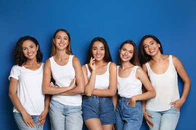 Photo of Happy women on blue background. Girl power concept