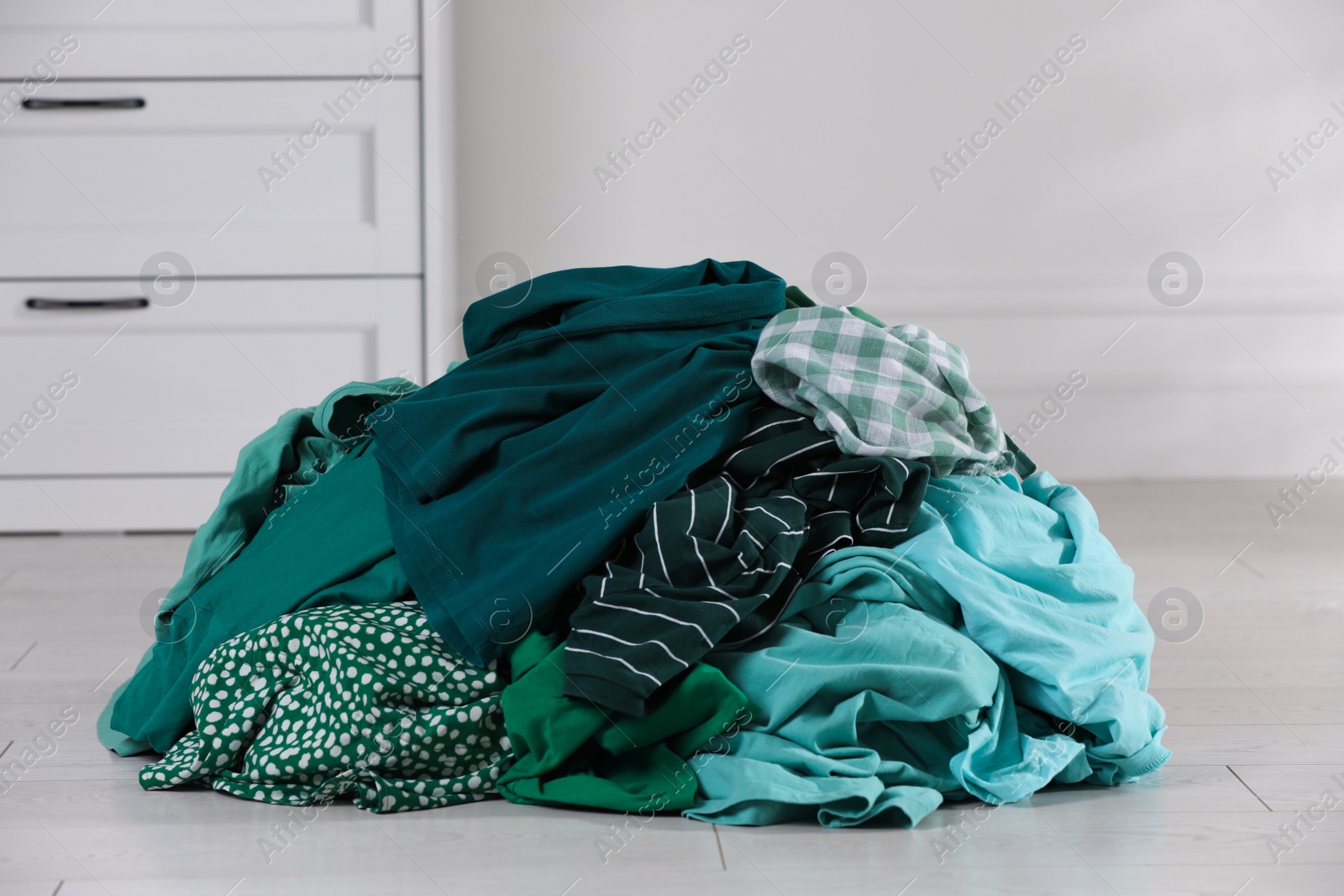 Photo of Pile of dirty clothes on floor indoors