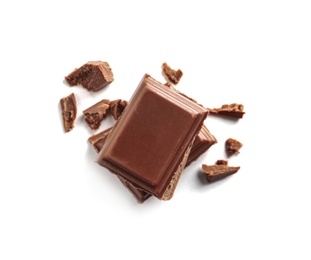 Pieces of tasty milk chocolate on white background, top view