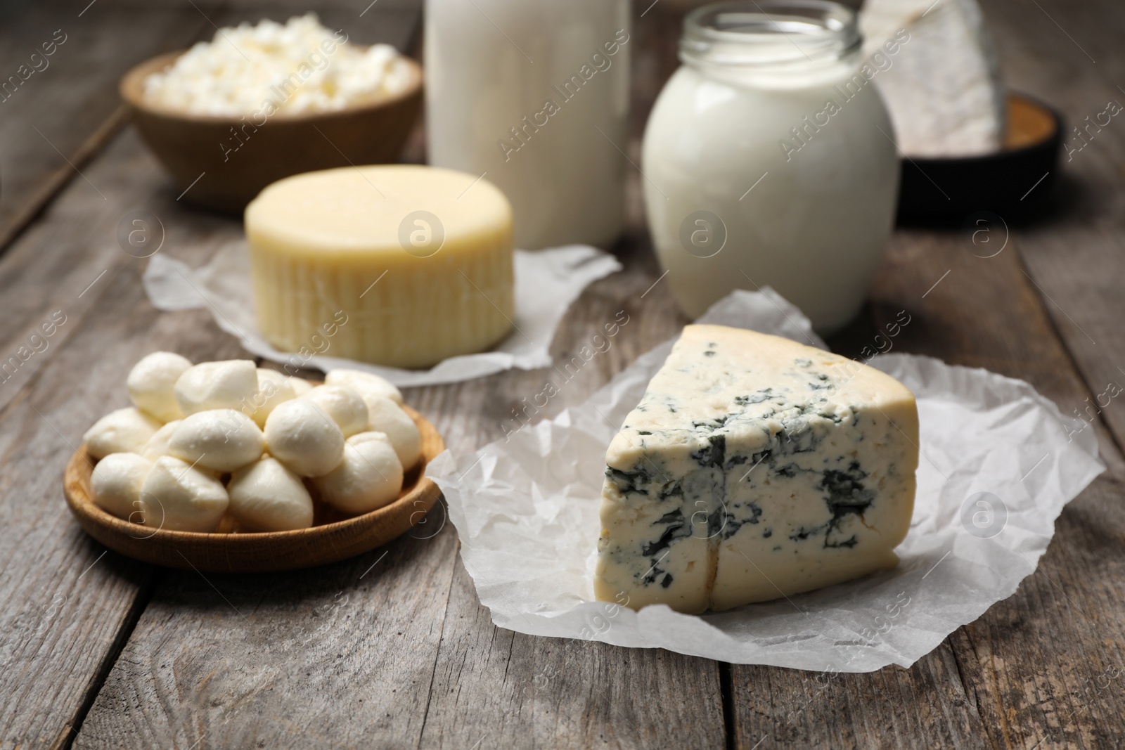 Photo of Different fresh dairy products on wooden table