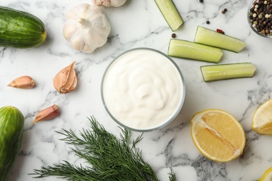 Photo of Flat lay composition with cucumber sauce and ingredients on marble background