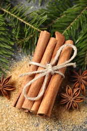 Different spices and fir branches on table, flat lay