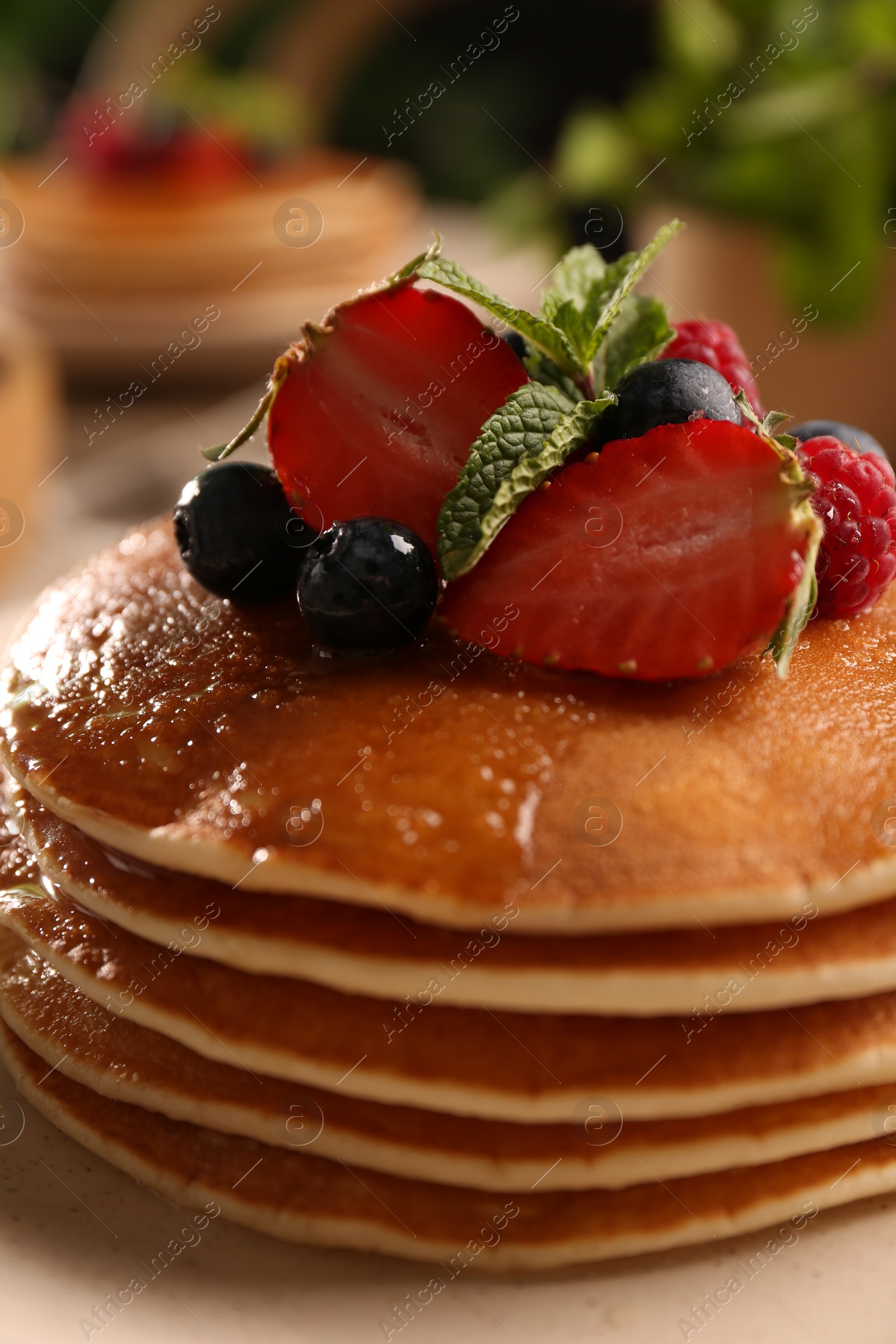 Photo of Tasty pancakes with fresh berries and mint on plate, closeup