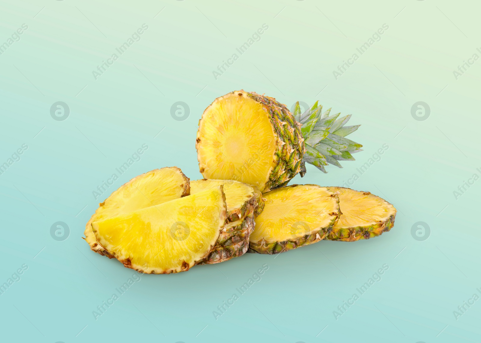 Image of Cut fresh juicy pineapple on light blue background