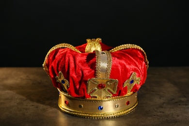 Photo of Beautiful velvet crown on grey table. Fantasy item