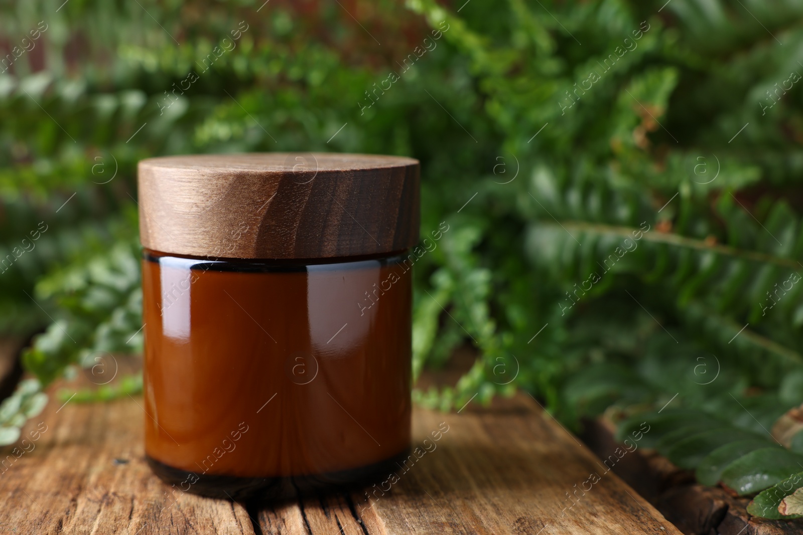 Photo of Jar of luxury cream on wooden table, space for text