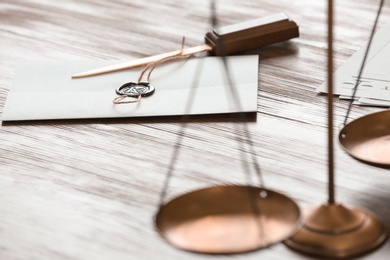 Photo of Document with notary seal and letter opener on wooden table