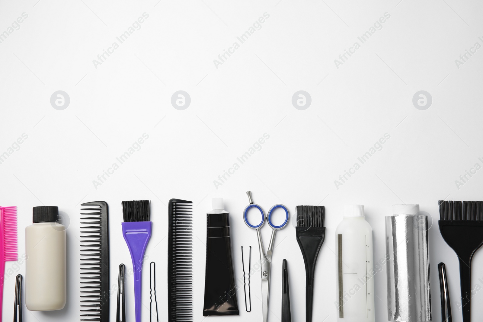 Photo of Professional tools for hair dyeing on white background, flat lay. Space for text