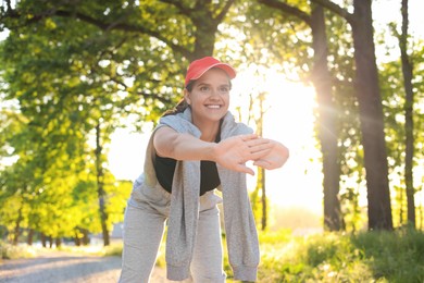 Young woman doing morning exercise in park