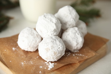 Photo of Tasty Christmas snowball cookies on light table, closeup