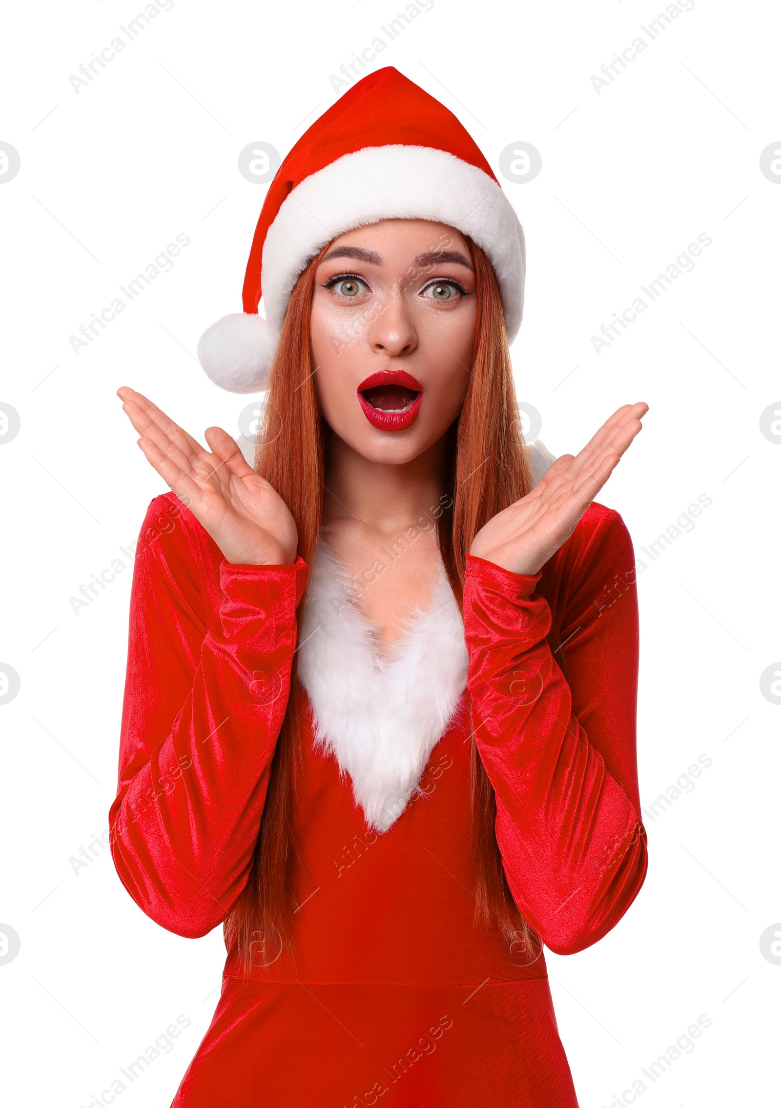Photo of Emotional young woman in red dress and Santa hat on white background. Christmas celebration
