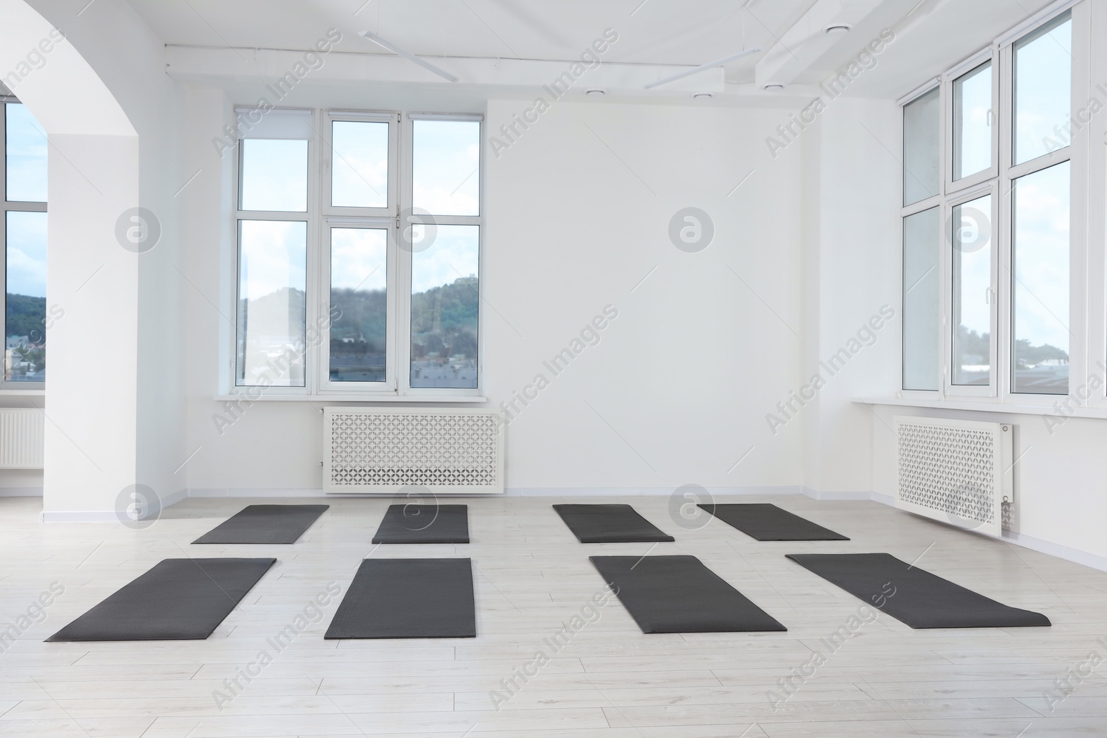 Photo of Spacious yoga studio with exercise mats and big windows