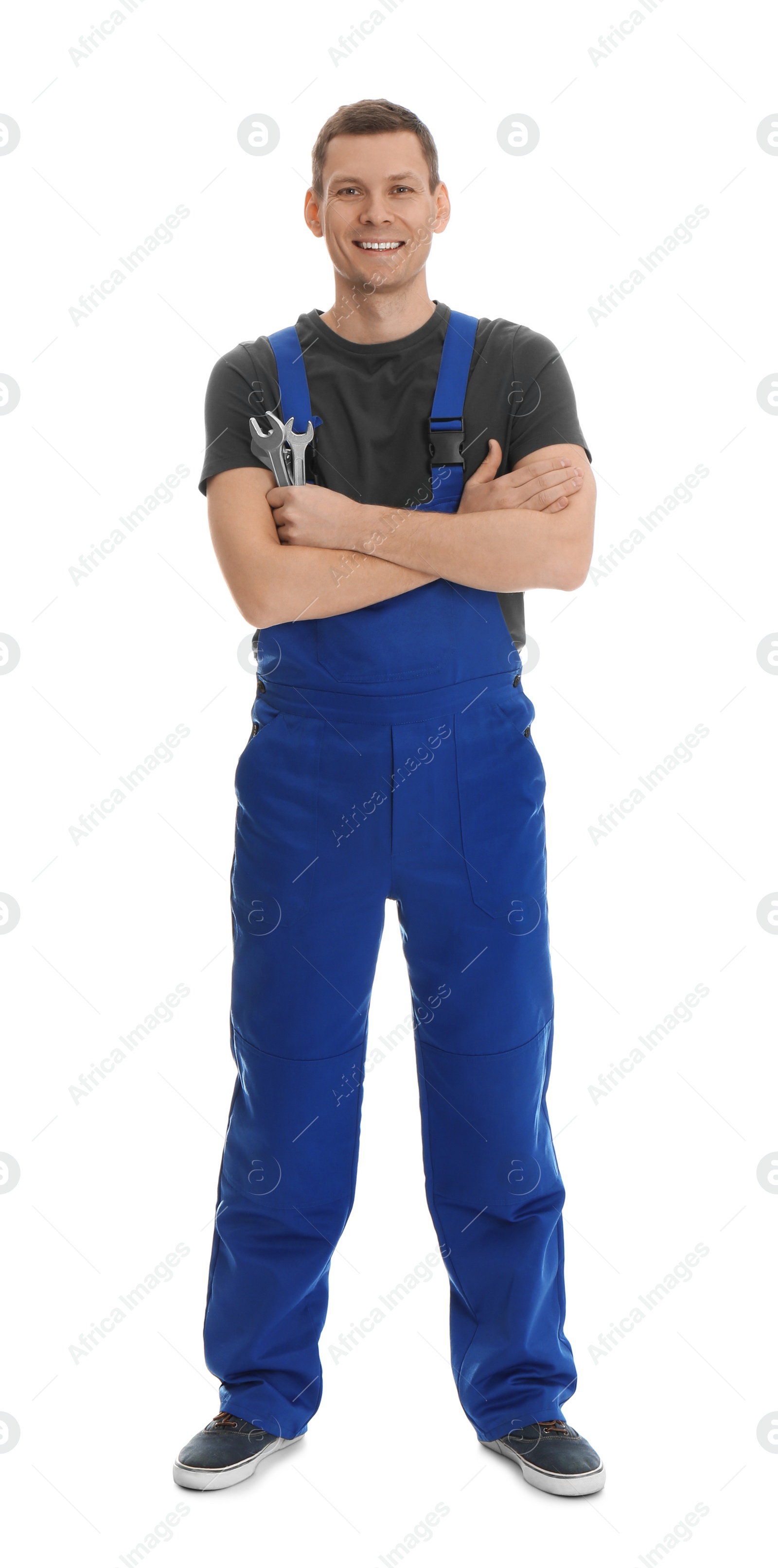 Photo of Full length portrait of professional auto mechanic with wrenches on white background